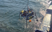 A lander with diverse sensors is lowered into the Baltic Sea from aboard a research vessel to carry out measurements at the seafloor.