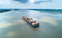 Aerial view of the Elbe estuary with container cargo ship