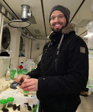 BRIESE-Preisträger Iason-Zois Gazis, hier im Kühllabor bei 4 °C an Bord des deutschen Forschungsschiffs SONNE bei der Vermessung von Manganknollen aus dem Pazifischen Ozean.